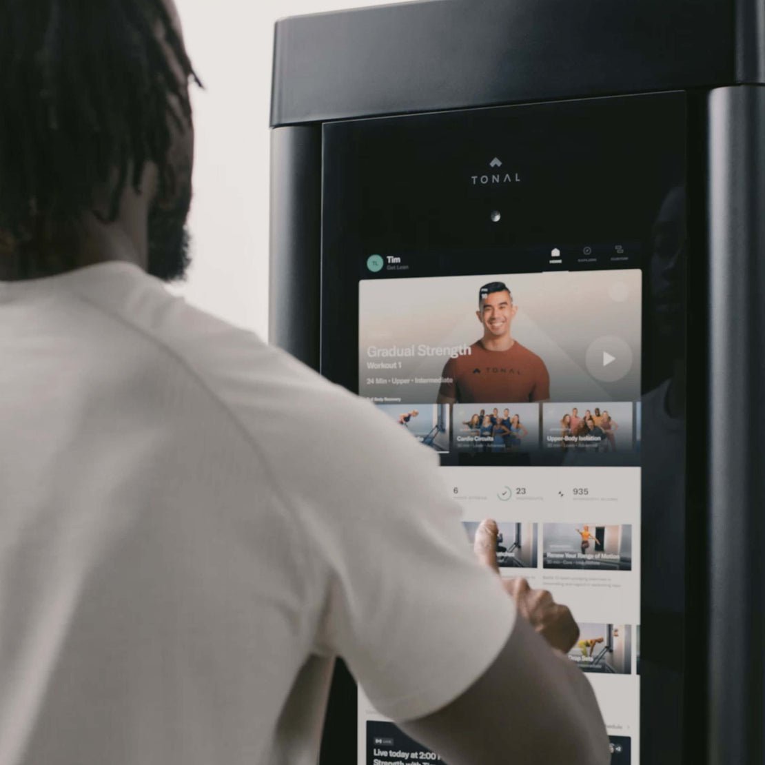 A customer choosing a workout on Tonal’s screen.